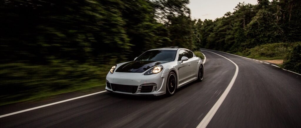 Vehicle driving on a road representing Ronor Motors automotive experience